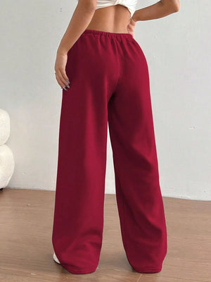 Red wide-leg pants worn by a person on a plain background