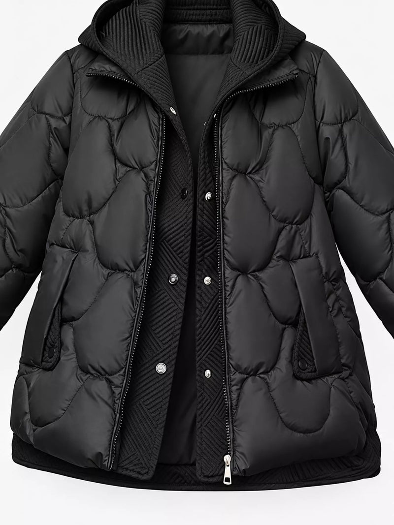 A black quilted puffer jacket with a hood, featuring a front zipper and snap-button closure over a matching black ribbed inner layer, shown against a plain white background.