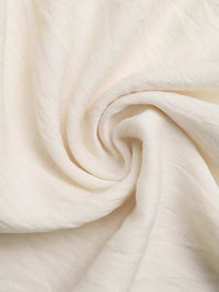Close-up of beige fabric with folds