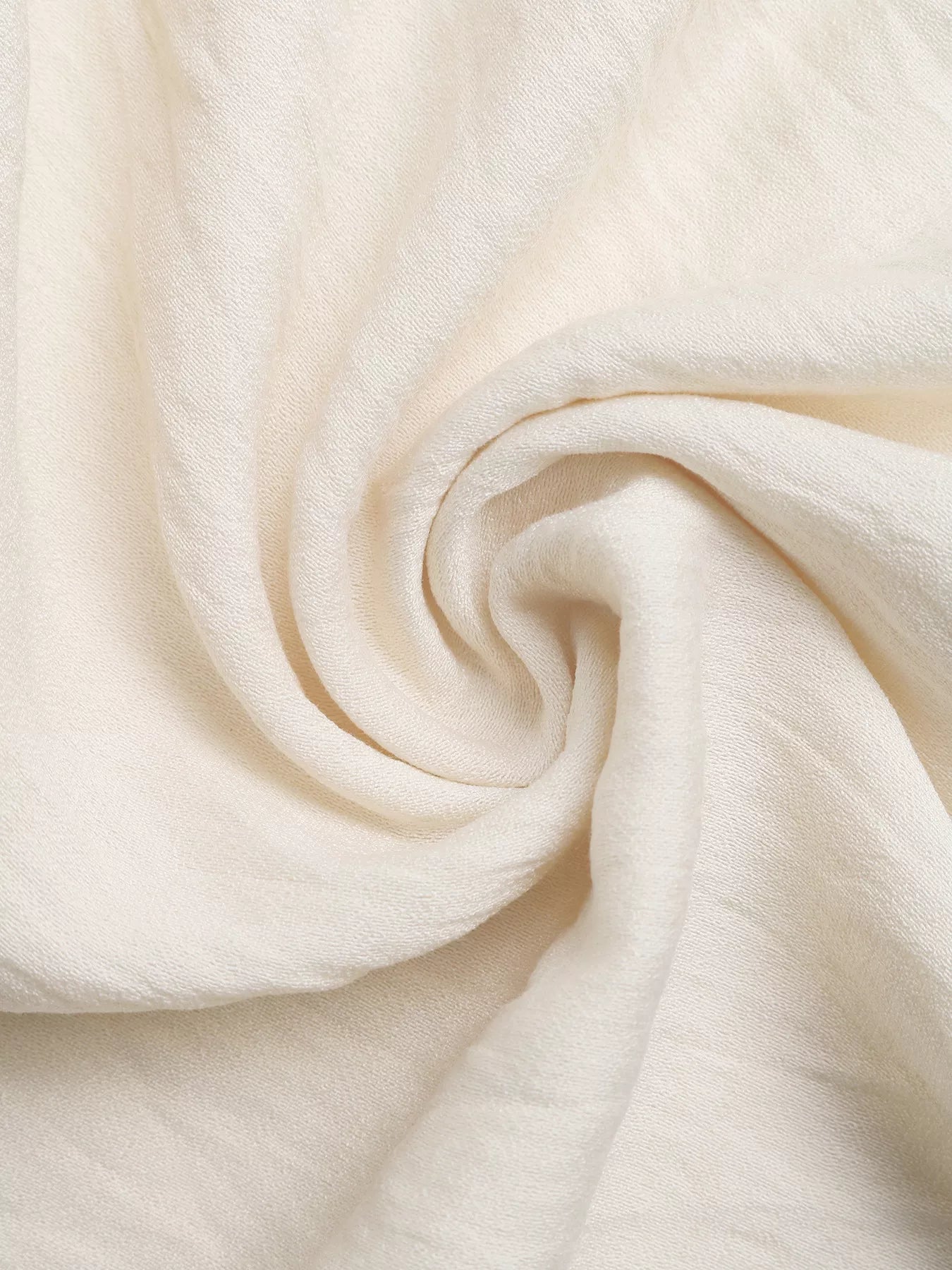 Close-up of beige fabric with folds