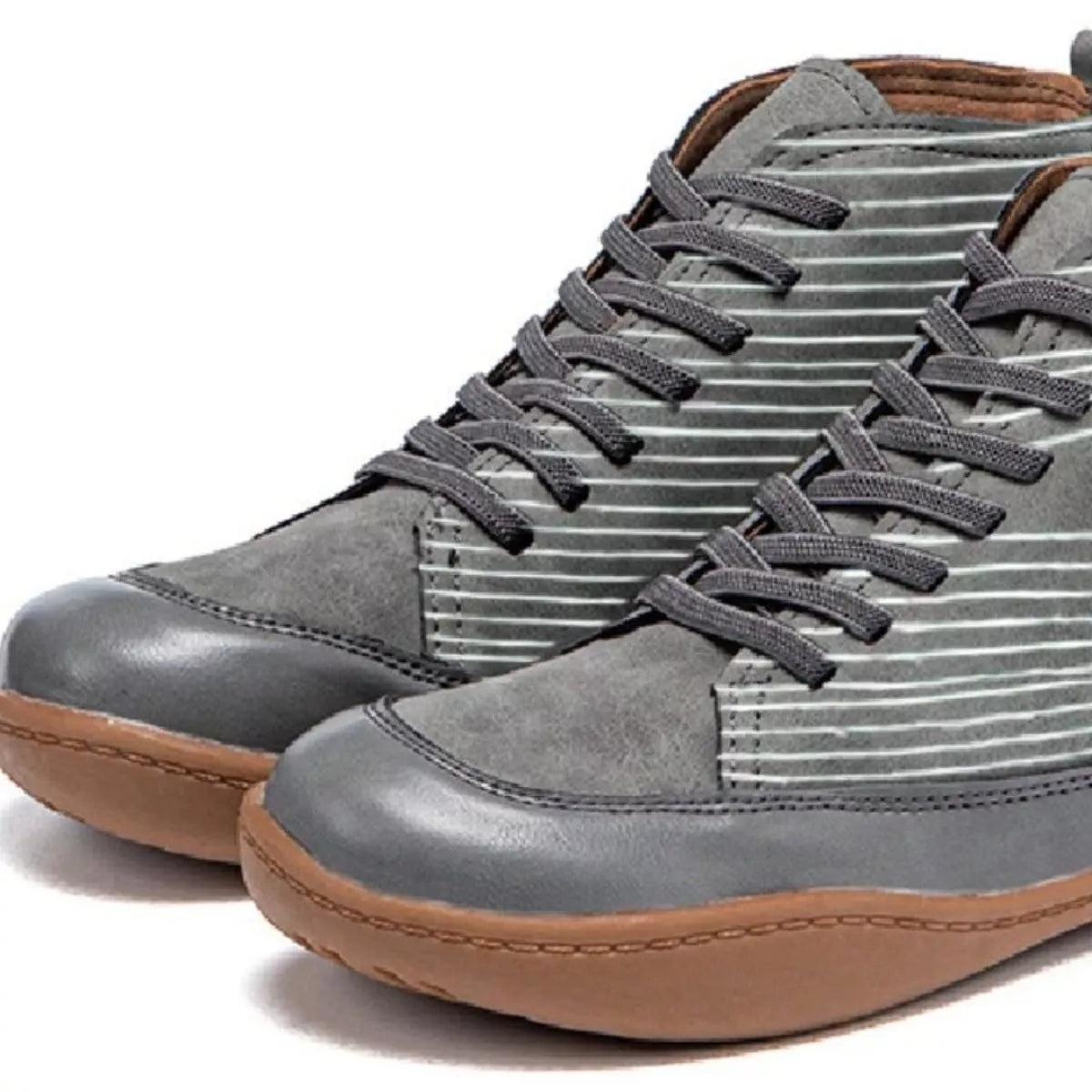 Gray high-top sneakers with brown soles on a white background