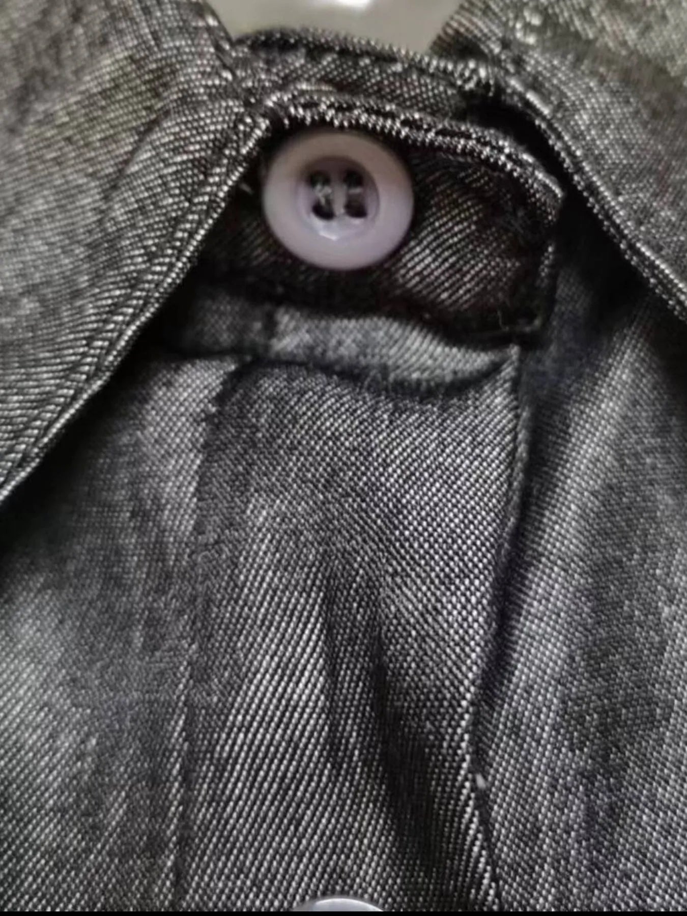 Close-up of a button on a textured fabric surface