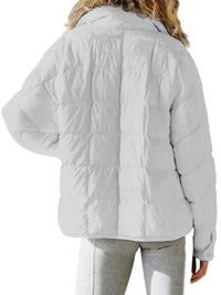 Light gray puffer jacket worn by a person on a white background