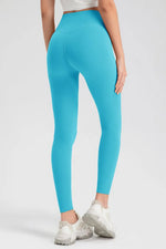Person wearing bright blue leggings on a white background