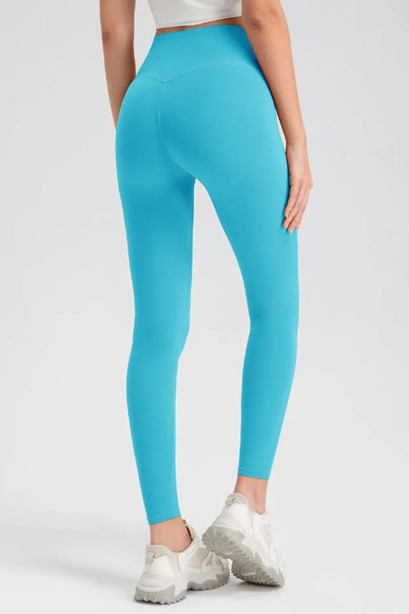 Person wearing bright blue leggings on a white background