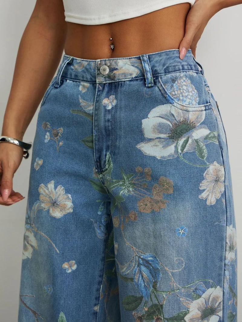 Floral-patterned jeans worn by a person on a plain background