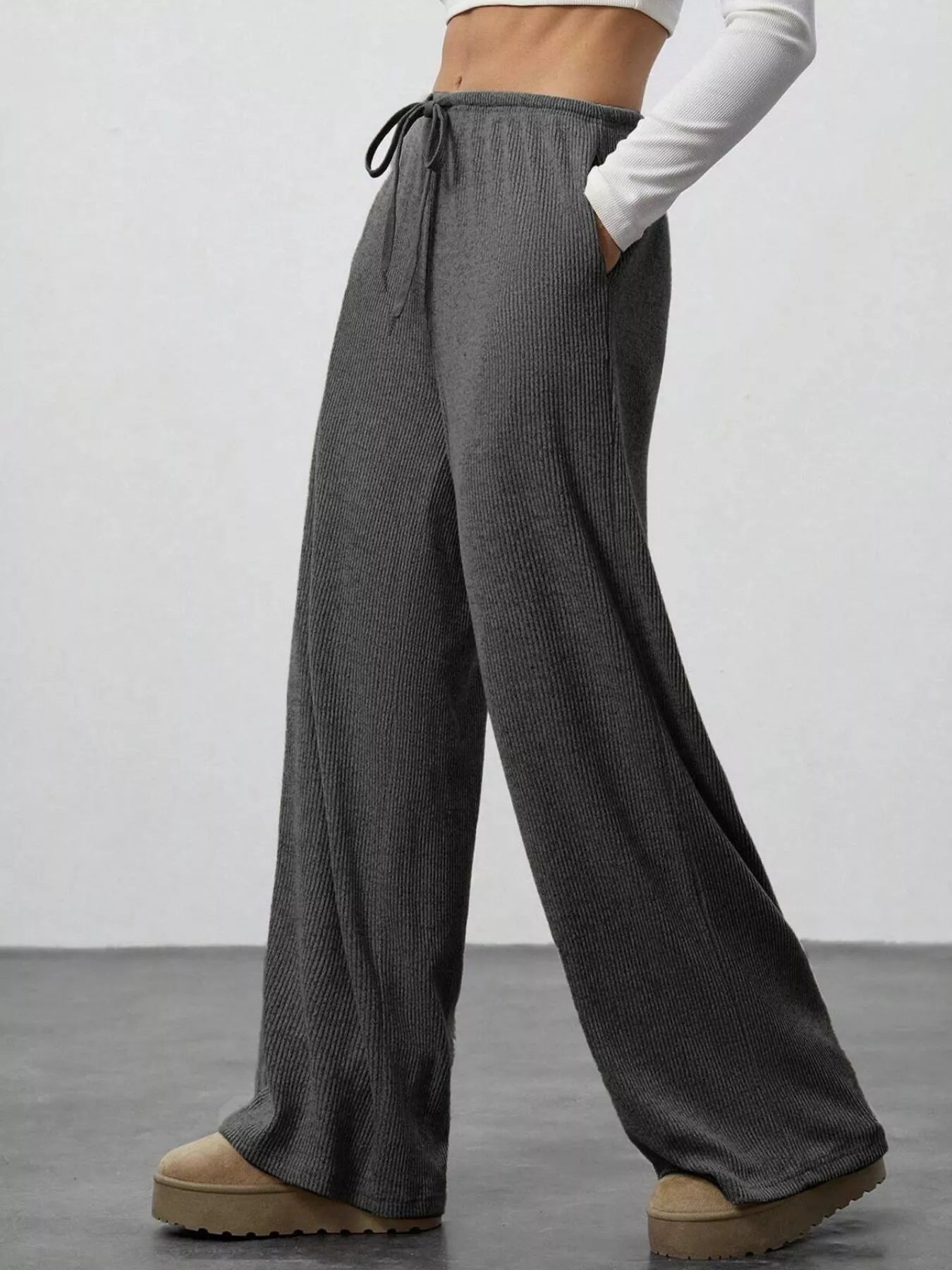 Gray textured wide-leg pants worn by a person on a plain background