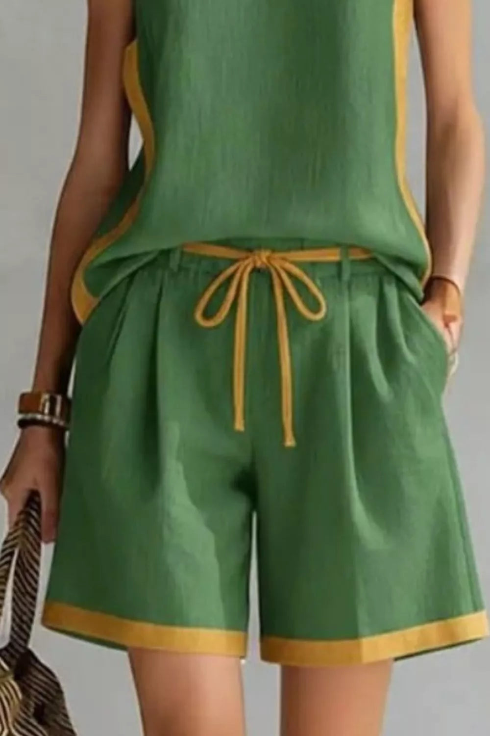 Green outfit with yellow trim on a plain background
