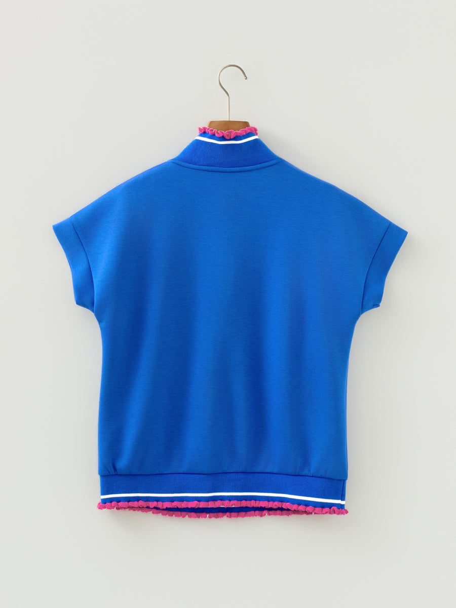 Blue sleeveless top with pink trim on a hanger against a light gray background