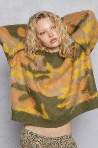 Woman wearing a patterned sweater with a plain background