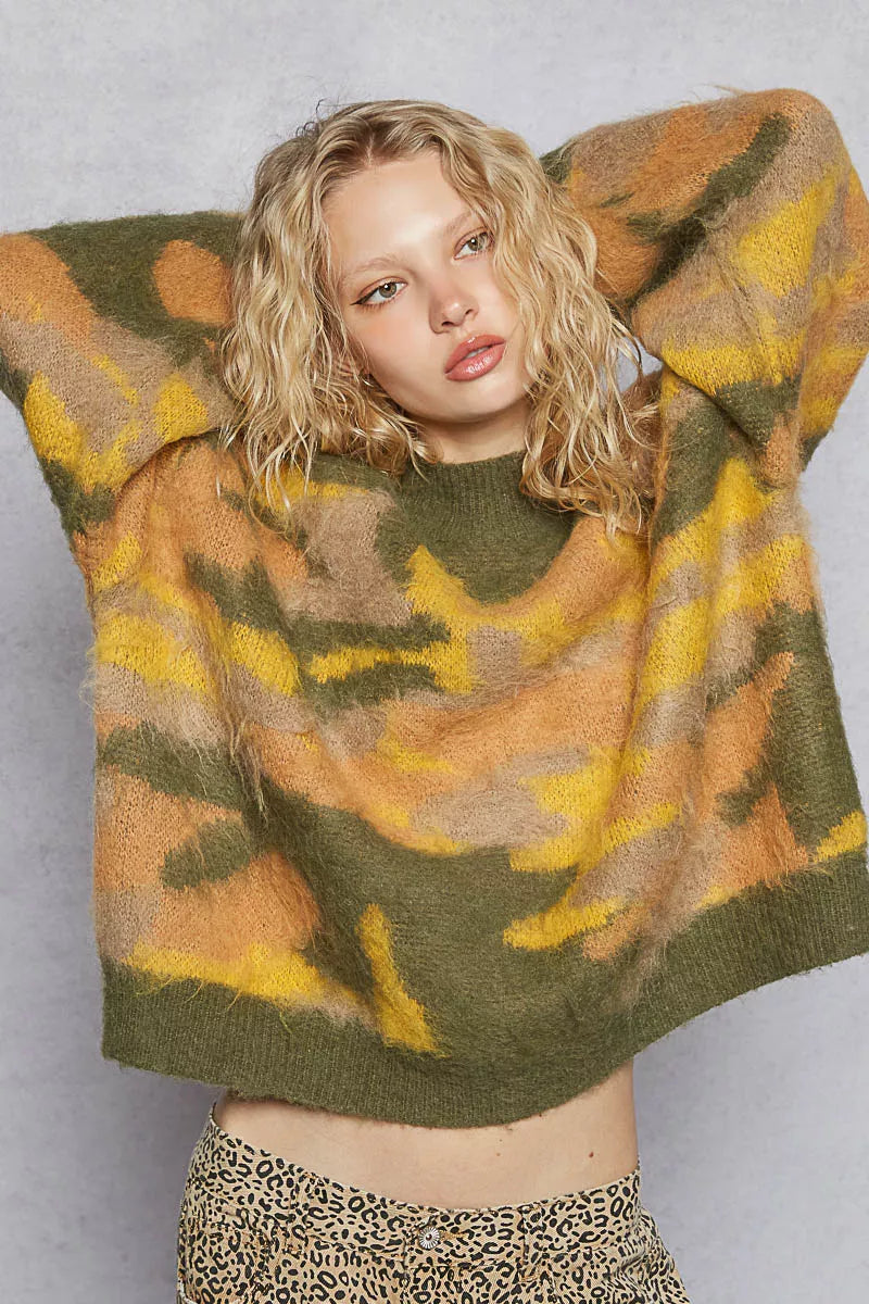 Woman wearing a patterned sweater with a plain background