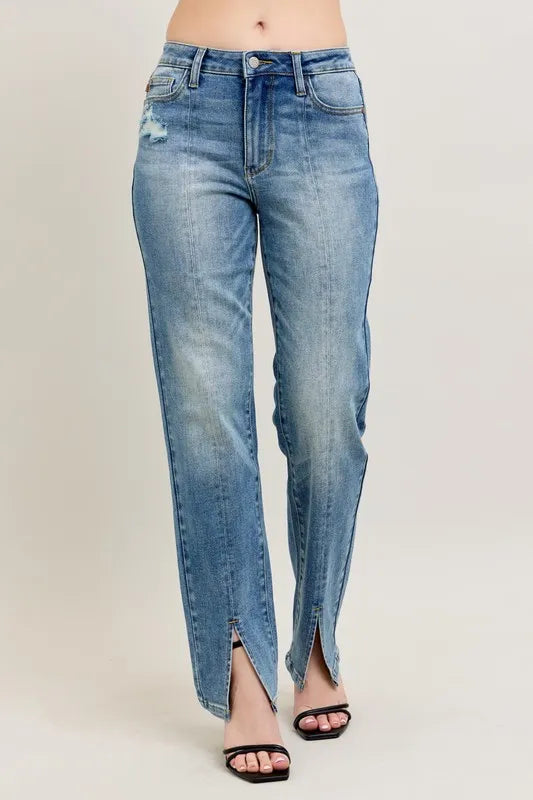 Blue jeans with a slit on a plain background