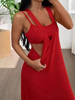 Woman wearing a red dress with cut-out design indoors.