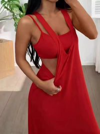 Woman wearing a red dress with cut-out design indoors.