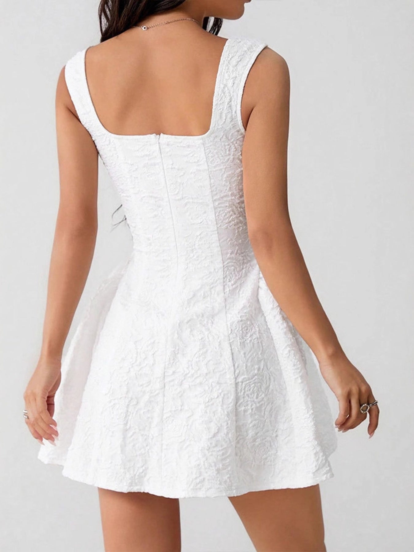 White lace dress on a plain background