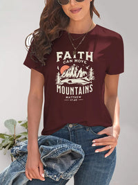 Person wearing a maroon t-shirt with 'Faith can move mountains' graphic design.