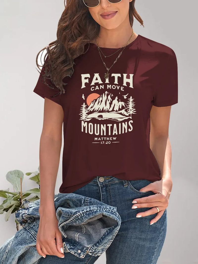 Person wearing a maroon t-shirt with 'Faith can move mountains' graphic design.