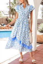 Woman wearing a blue floral dress by a poolside