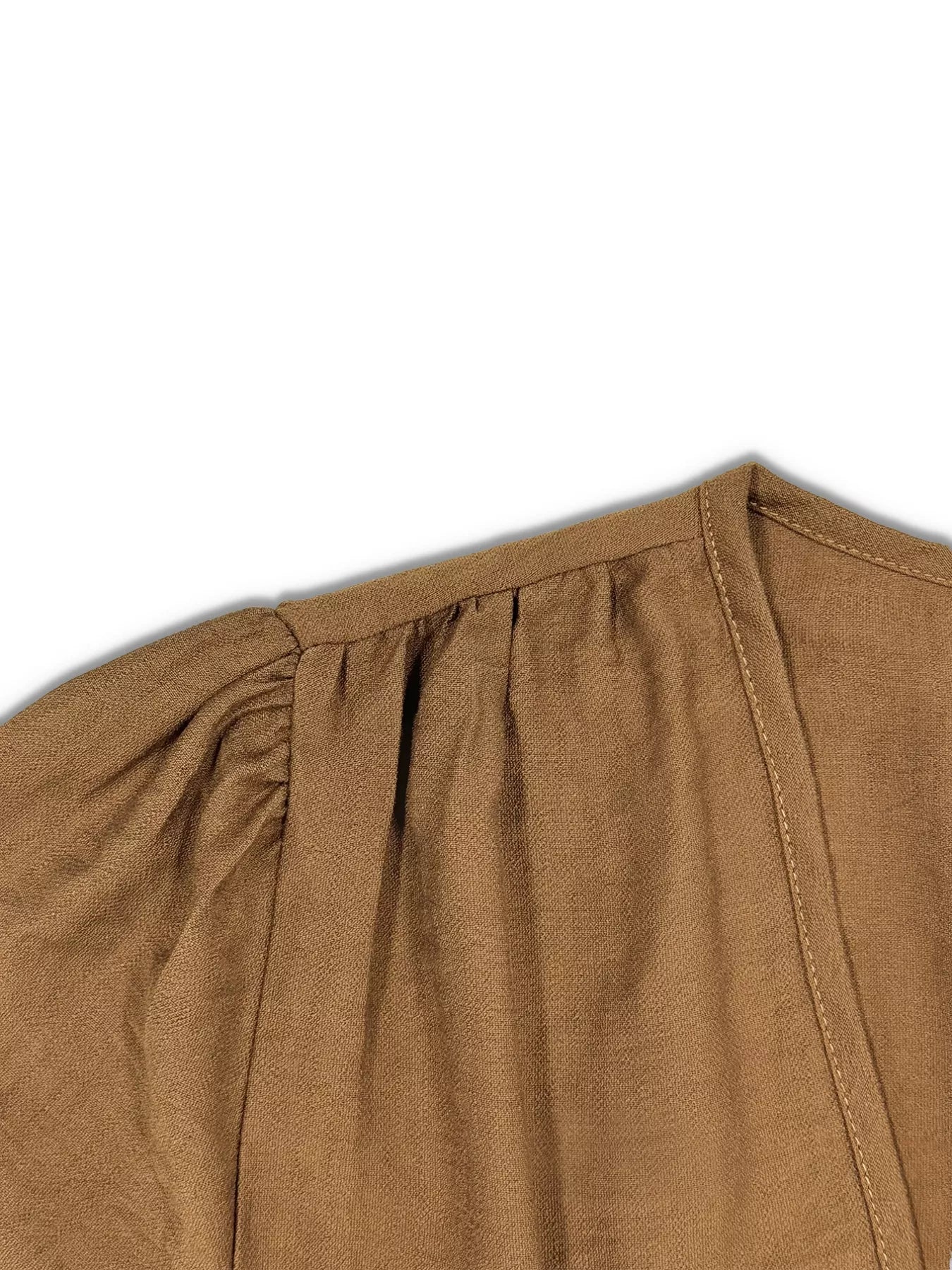 Close-up of a brown garment with a white background