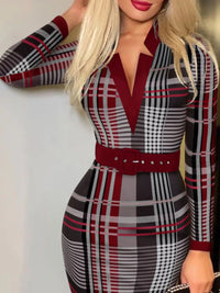 Woman wearing a plaid dress with red accents against a white background