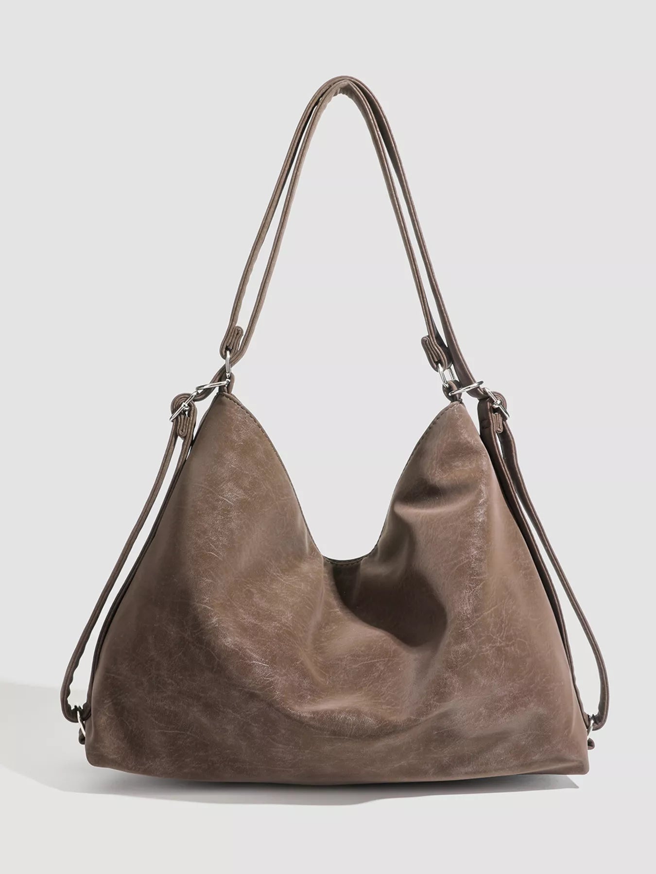 Brown leather handbag on a light gray background