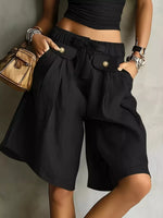 Woman wearing a black High-Waisted Drawstring Shorts posing with her hands in the pockets