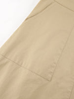 Close-up of beige pants with a pocket on a white background