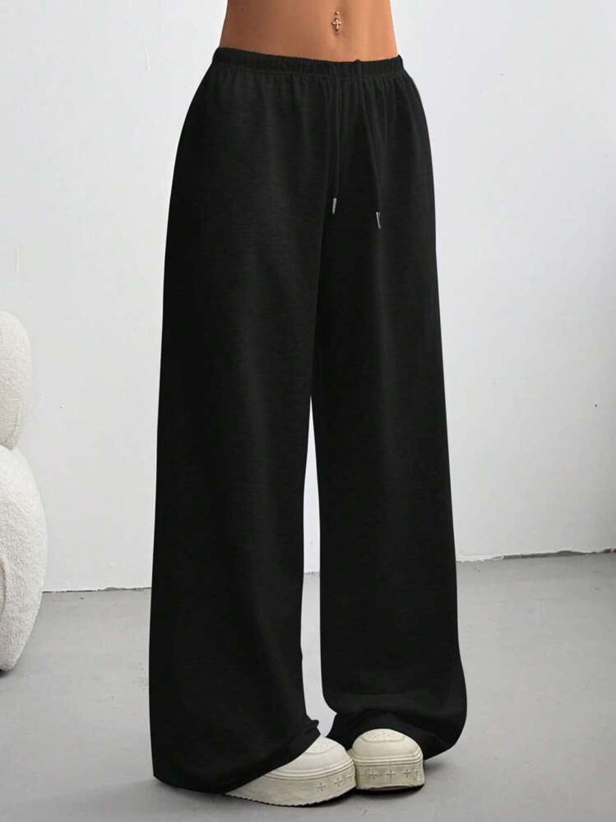Black wide-leg pants worn by a person on a plain background