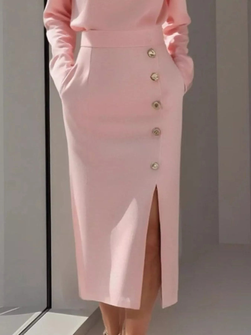 Pink skirt with button details on a plain background