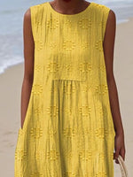 Person wearing a yellow dress with a beach background