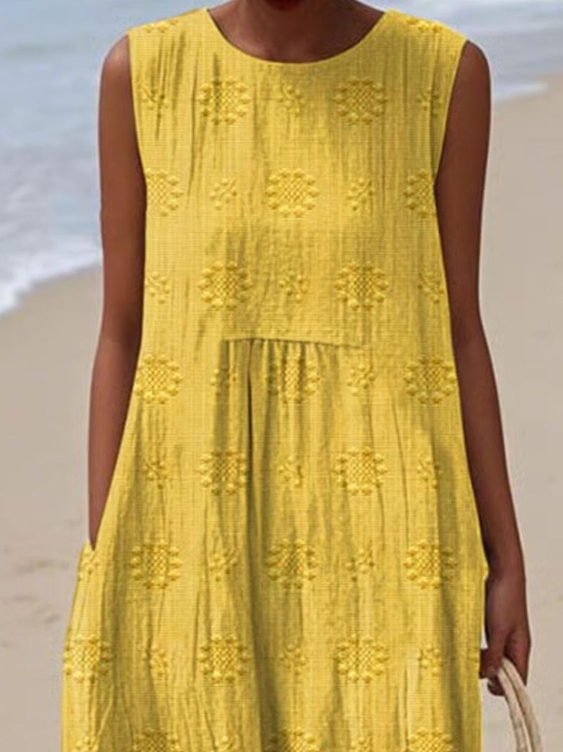 Person wearing a yellow dress with a beach background
