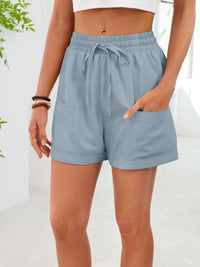 Light blue shorts worn by a person on a white background