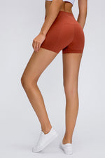 Person wearing rust-colored shorts on a white background
