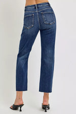 Blue jeans worn by a person on a white background