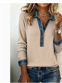 Beige sweater with denim collar and cuffs worn by a person on a plain background