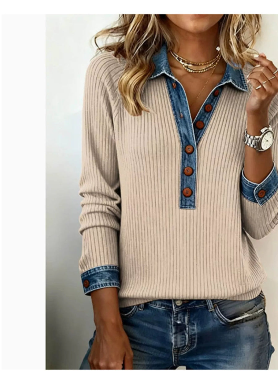 Beige sweater with denim collar and cuffs worn by a person on a plain background