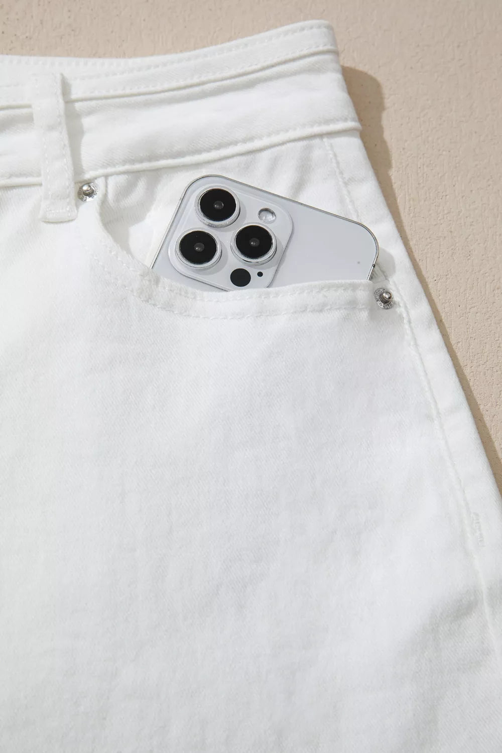 Smartphone with camera module sticking out of a white pocket