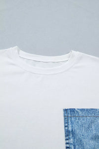 White t-shirt with a blue denim pocket on a gray background