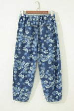 Blue floral jeans hanging on a white background