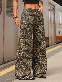 Person wearing leopard print pants on a subway platform
