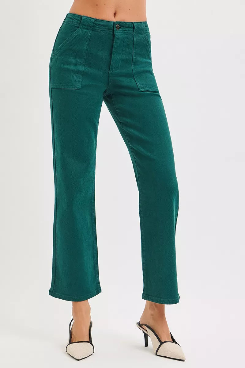 Green pants worn by a person on a white background