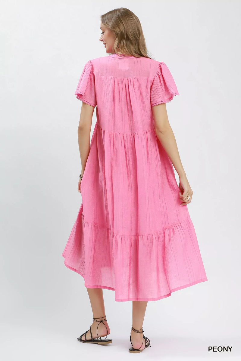 Woman wearing a pink dress on a white background