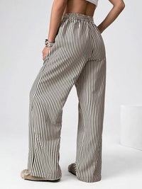 Person wearing striped wide-leg pants on a white background