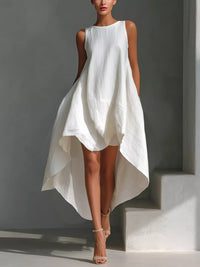 White dress worn by a model against a gray background
