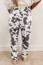 Person wearing camouflage pants with a plain background