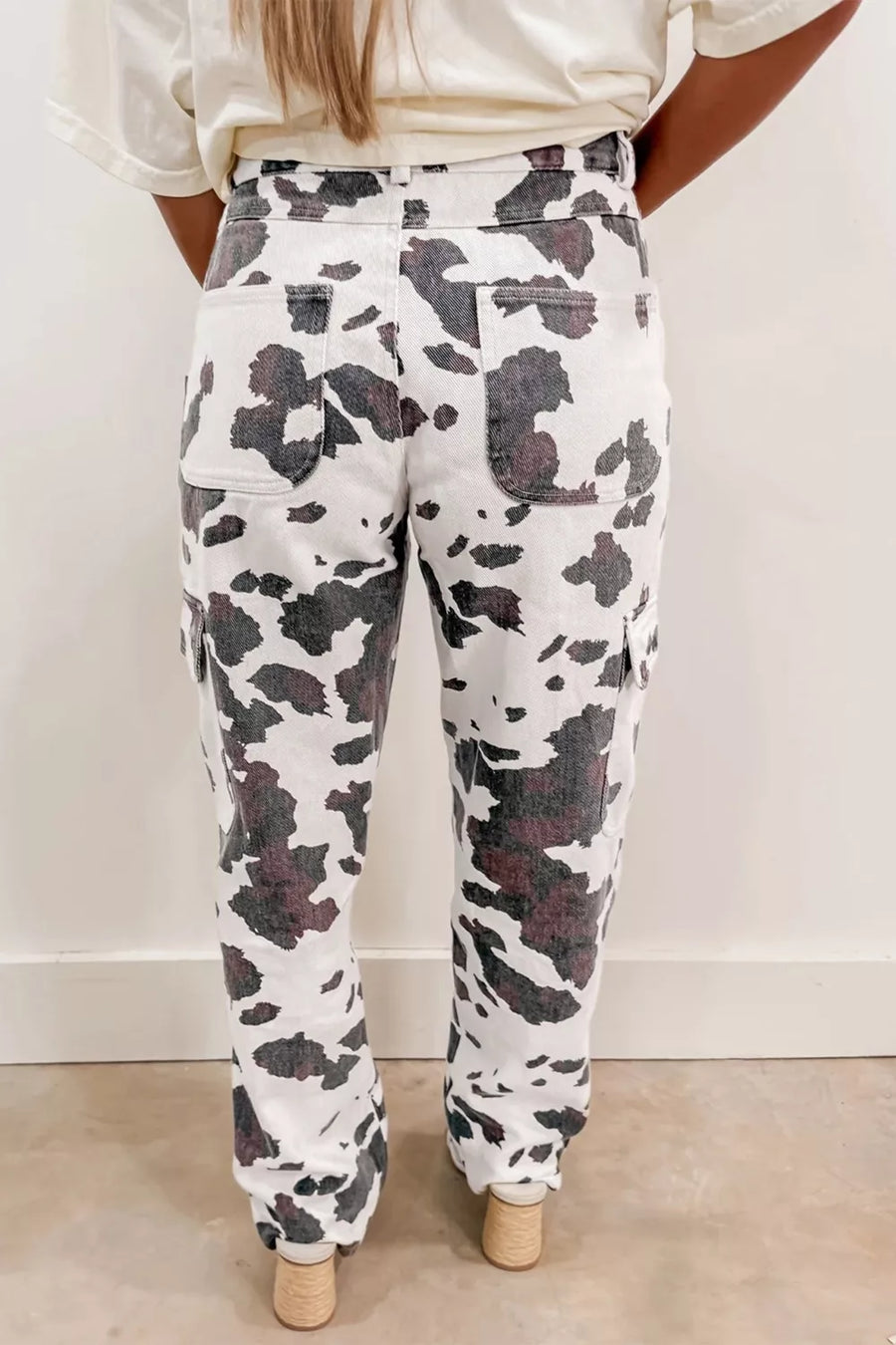 Person wearing camouflage pants with a plain background