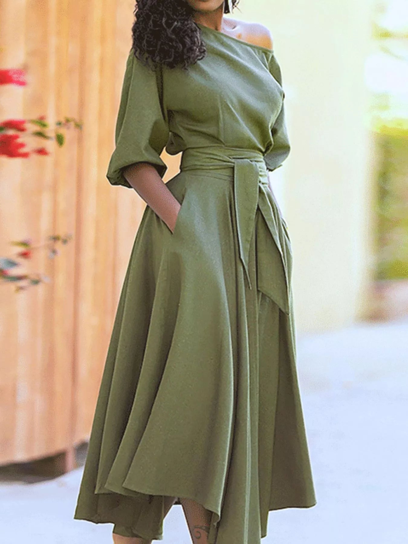 Woman wearing a green dress with a blurred background