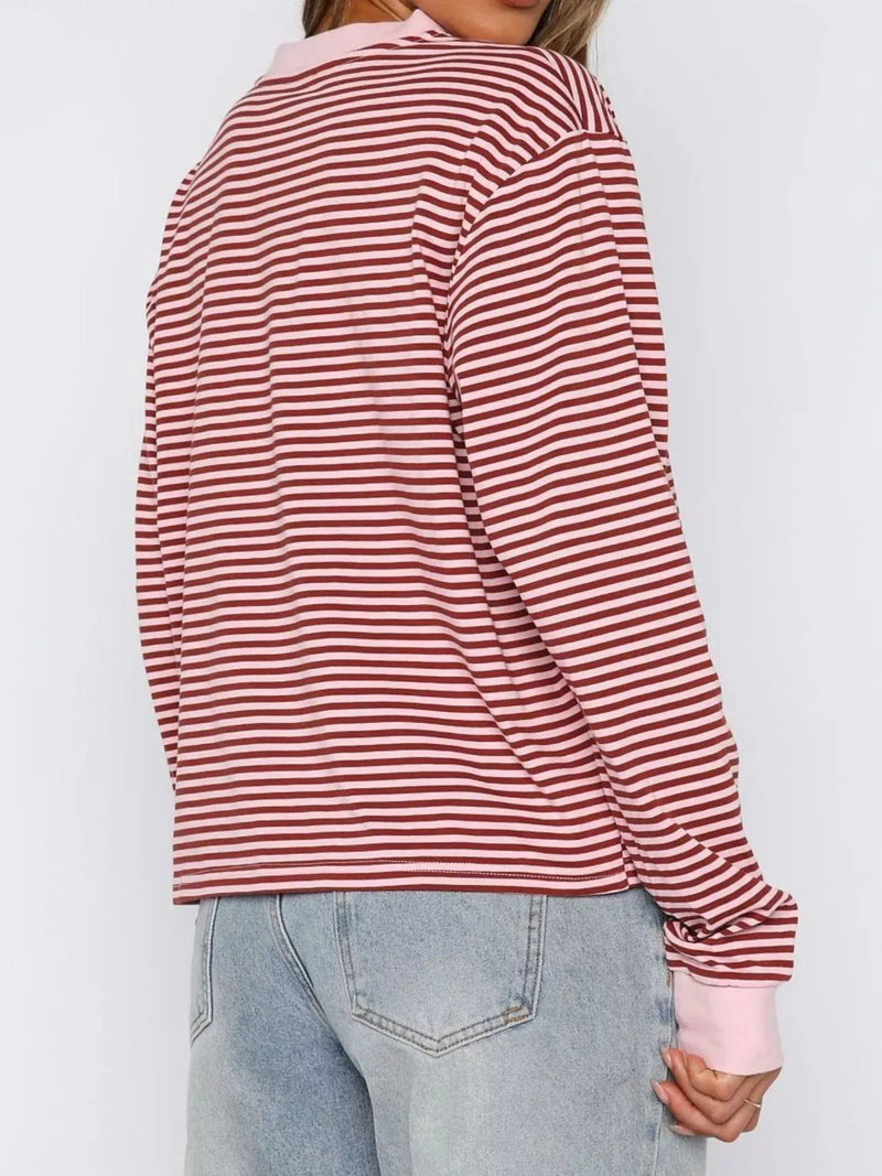 Red and white striped long-sleeve shirt worn by a person on a plain background