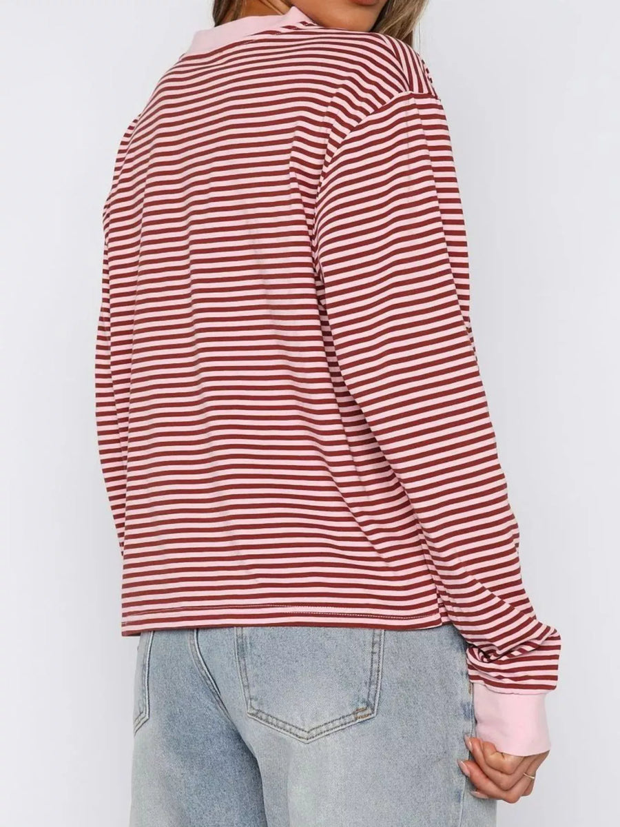Red and white striped long-sleeve shirt worn by a person on a plain background
