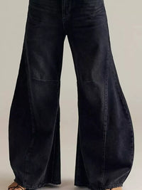 Black wide-leg jeans on a neutral background
